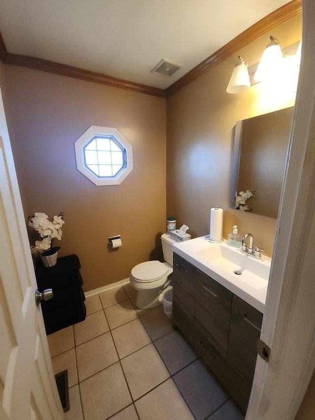 bathroom featuring tile patterned flooring, vanity, toilet, and crown molding