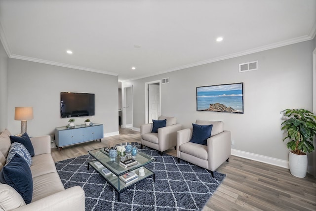 living room with wood-type flooring and crown molding