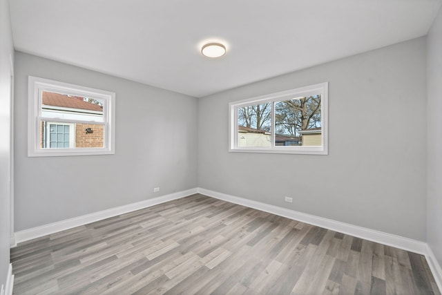 spare room featuring plenty of natural light and light hardwood / wood-style floors