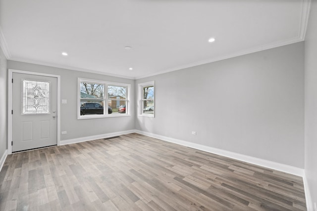 foyer featuring light hardwood / wood-style floors and crown molding