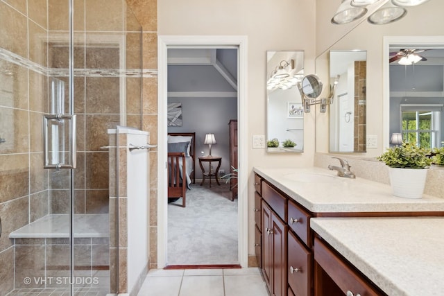 ensuite bathroom with tile patterned flooring, a shower stall, vanity, and ensuite bathroom