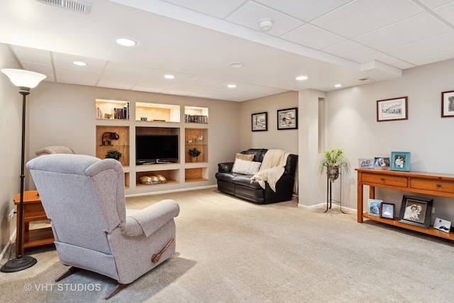 carpeted living area featuring a paneled ceiling, recessed lighting, visible vents, built in features, and baseboards