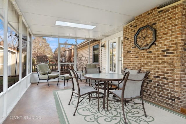 sunroom with a skylight and a healthy amount of sunlight