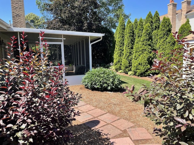 view of patio featuring a sunroom