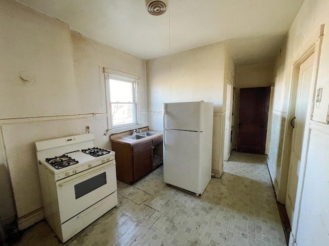 kitchen with white appliances and sink