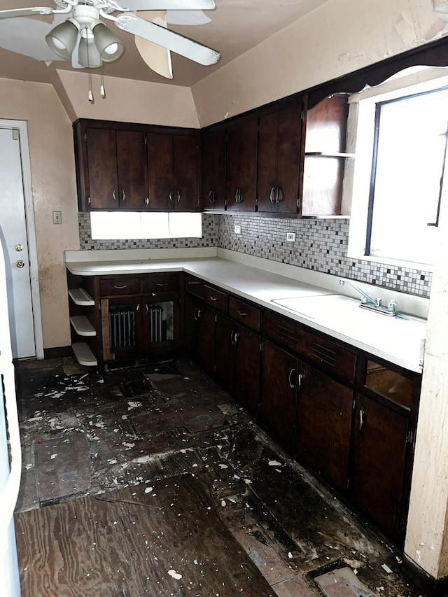 kitchen with backsplash, sink, vaulted ceiling, ceiling fan, and dark brown cabinets