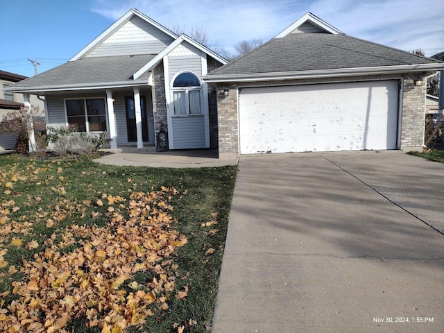 view of front of home featuring a garage and a front lawn