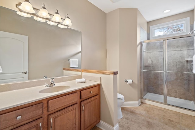 bathroom with tile patterned floors, a shower with door, vanity, and toilet