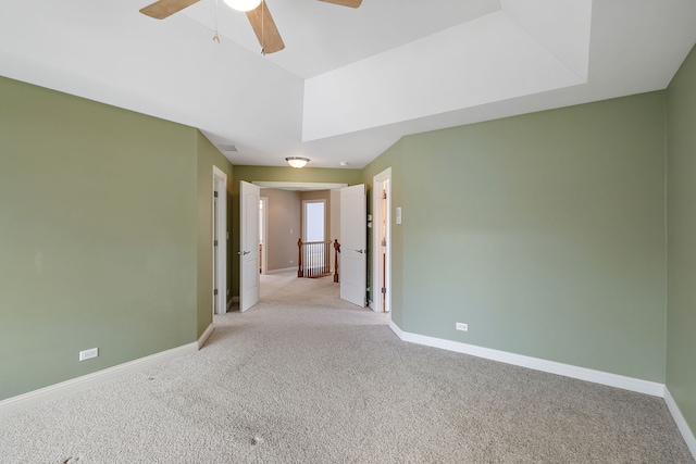 carpeted empty room featuring ceiling fan