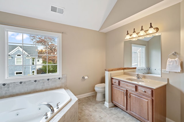 bathroom with vanity, lofted ceiling, tile patterned floors, toilet, and tiled tub