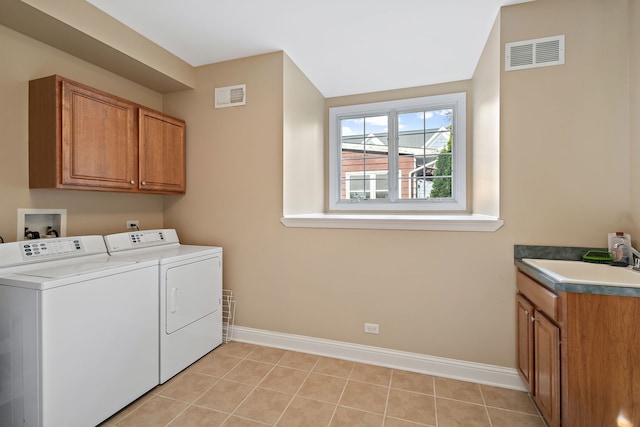 laundry room featuring cabinets, independent washer and dryer, light tile patterned floors, and sink