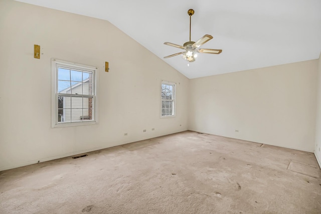 empty room with ceiling fan, light carpet, and vaulted ceiling