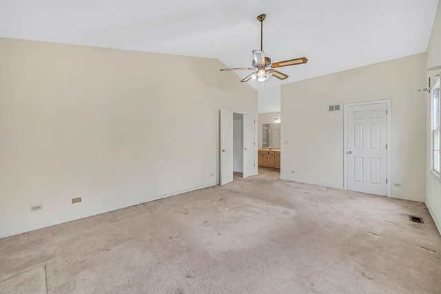 spare room featuring light colored carpet, high vaulted ceiling, and ceiling fan