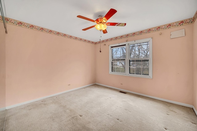 unfurnished room featuring ceiling fan and carpet