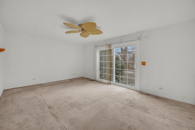 unfurnished room with light colored carpet and ceiling fan