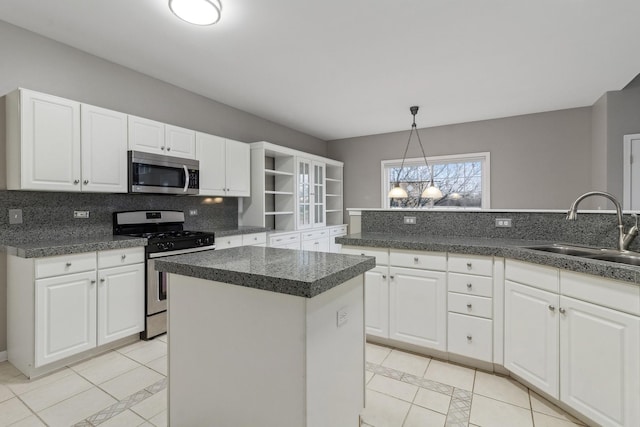 kitchen featuring a kitchen island, sink, white cabinetry, and stainless steel appliances