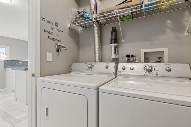 washroom featuring light tile patterned floors and washing machine and clothes dryer