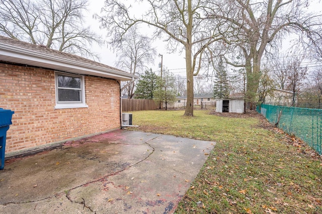 view of yard featuring a storage unit and a patio area