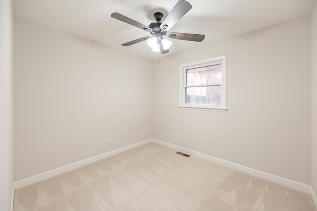 unfurnished room with light colored carpet and ceiling fan