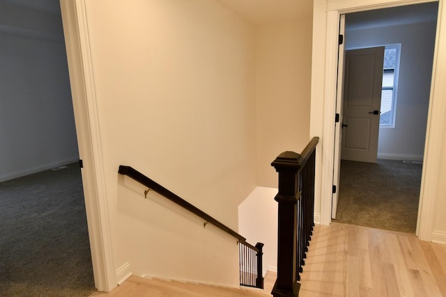 stairs with wood-type flooring