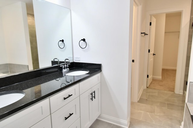 bathroom with tile patterned flooring and vanity