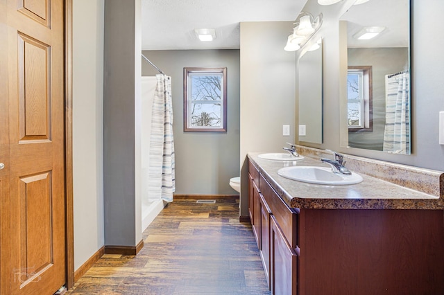 bathroom with a shower with curtain, vanity, toilet, and wood-type flooring