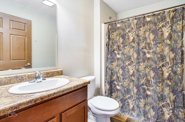 bathroom featuring vanity, toilet, a textured ceiling, walk in shower, and wood-type flooring