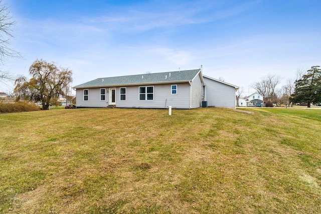 back of house featuring a yard and central AC unit