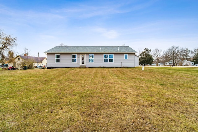 rear view of house with a lawn