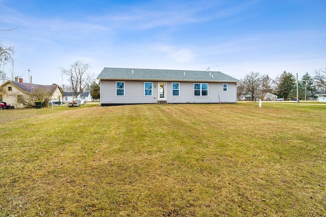 back of property featuring a yard