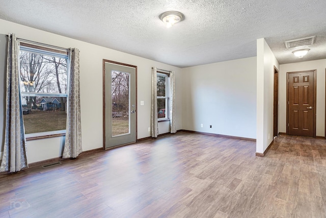 empty room featuring hardwood / wood-style floors and a textured ceiling