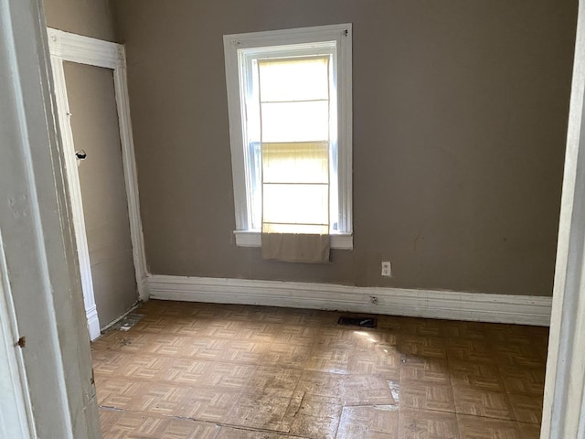 empty room with light parquet flooring