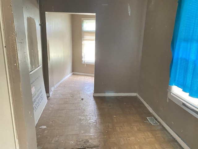 empty room with dark parquet flooring