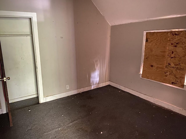 unfurnished bedroom with dark carpet