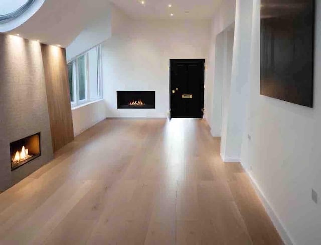 unfurnished living room featuring light hardwood / wood-style floors