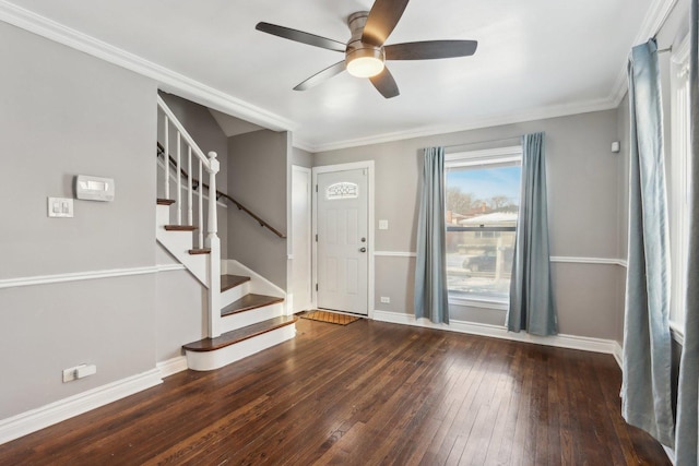 entryway featuring dark wood-type flooring, ceiling fan, and crown molding