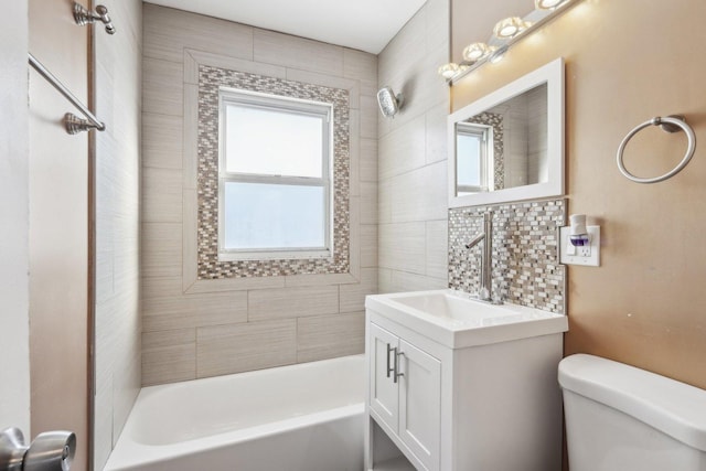 full bathroom with vanity, toilet, and tiled shower / bath