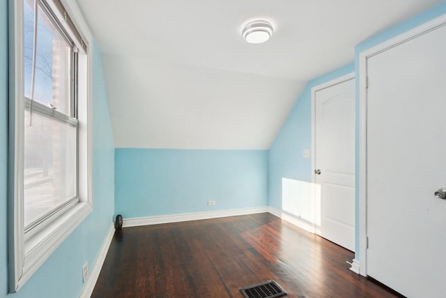 bonus room featuring plenty of natural light, dark hardwood / wood-style floors, and vaulted ceiling