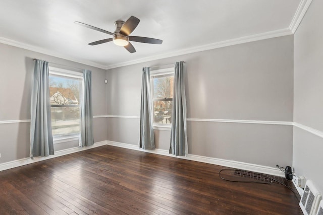 empty room with ceiling fan, dark wood-type flooring, and ornamental molding