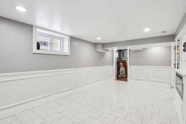 basement with light tile patterned flooring