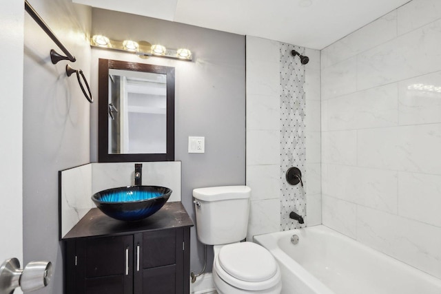 full bathroom featuring vanity, toilet, and tiled shower / bath