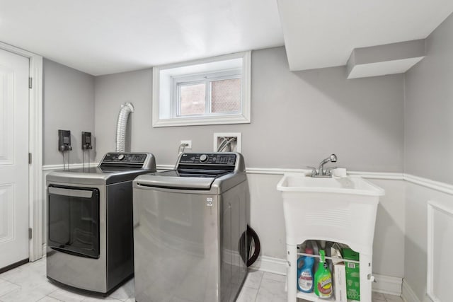 laundry room featuring light tile patterned flooring and separate washer and dryer