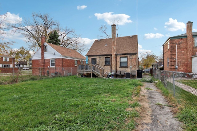 back of house with a yard and a wooden deck