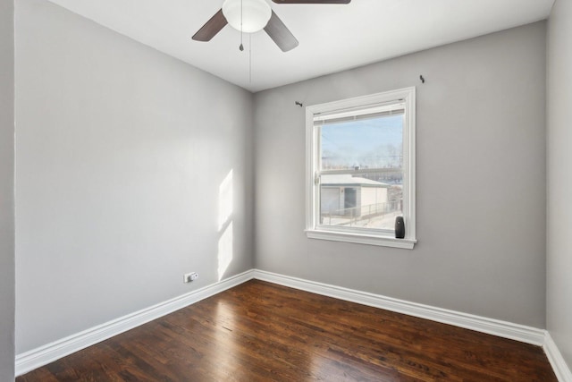 unfurnished room with ceiling fan and dark wood-type flooring