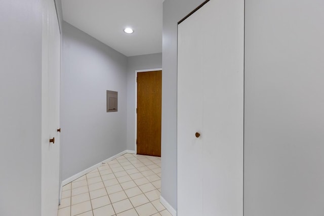 hallway with light tile patterned floors and electric panel