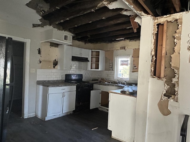 kitchen with dark wood-type flooring, sink, black electric range, tasteful backsplash, and white cabinetry