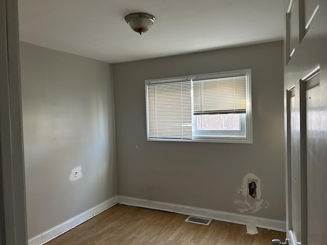 unfurnished room featuring wood-type flooring