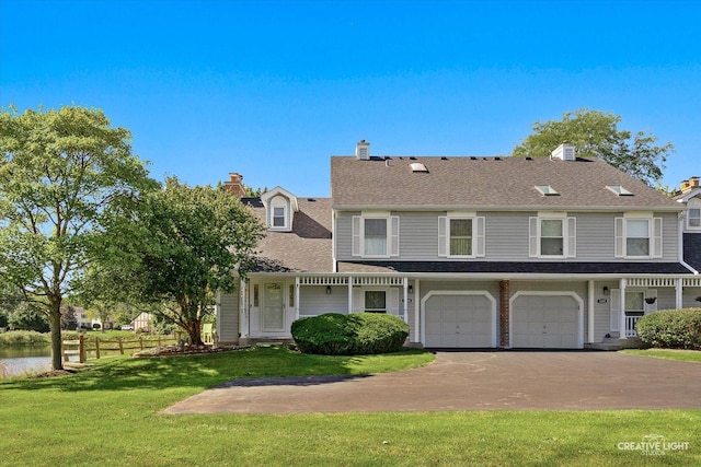 view of front facade with a garage and a front lawn