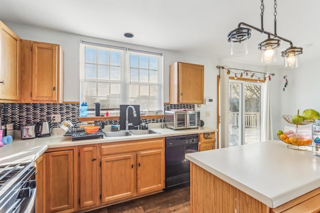 kitchen featuring dark hardwood / wood-style flooring, sink, decorative light fixtures, stainless steel range oven, and black dishwasher