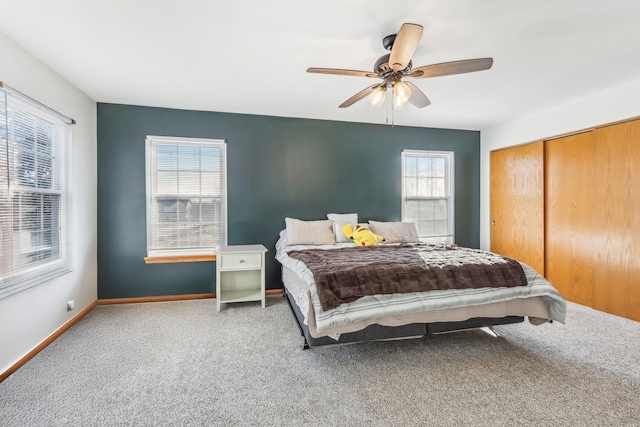 bedroom featuring carpet, ceiling fan, and multiple windows